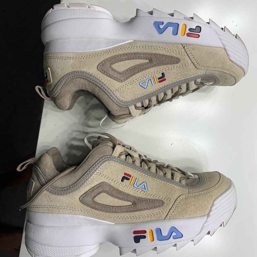 Women’s Filas size 6 1/2. Worn once. In great condition with one defect.